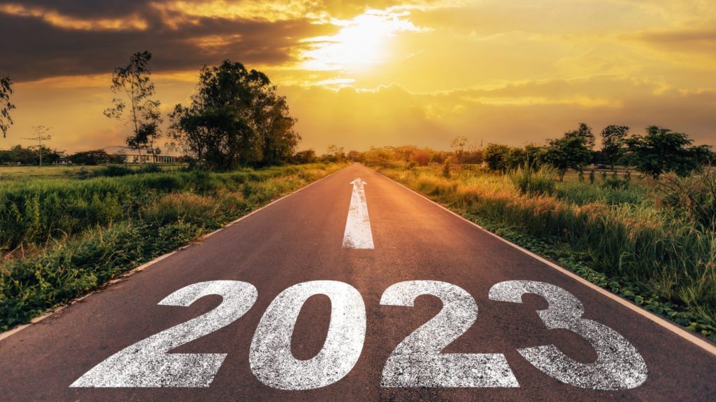 Empty asphalt road and New year 2023 concept. Driving on an empty road to Goals 2023 with sunset.